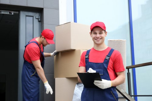Boxes and furniture being loaded into a removal truck