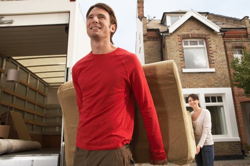 Movers navigating a busy West London street during a relocation