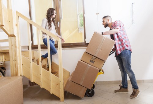 Trained movers handling boxes carefully during an Earls Court relocation