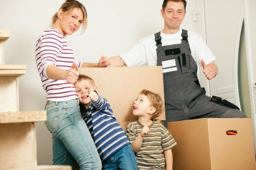 Professional movers handling furniture in a local London flat